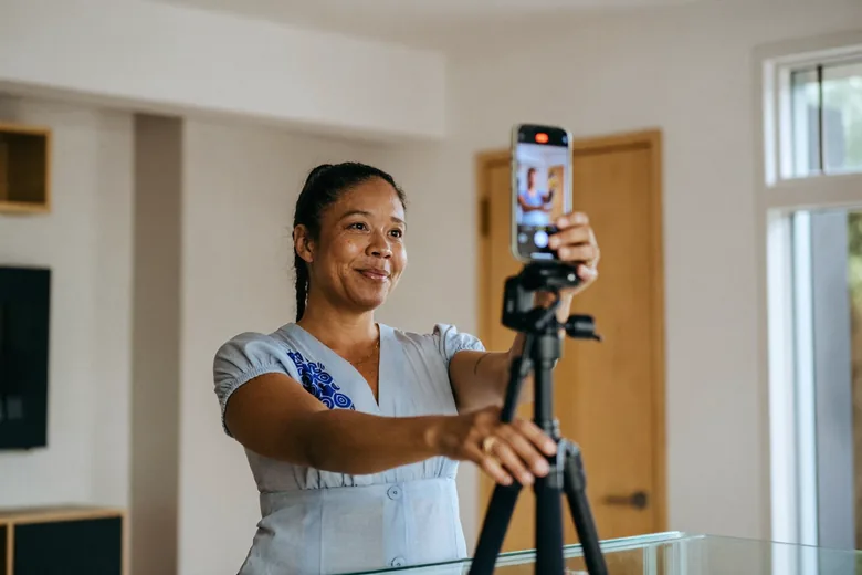 Dona de uma loja gravando um vídeo no celular dentro do próprio negócio